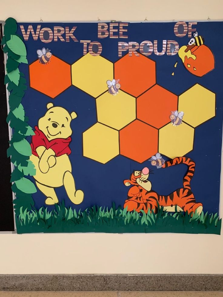 a bulletin board with winnie the pooh and tiggers on it in front of a wall