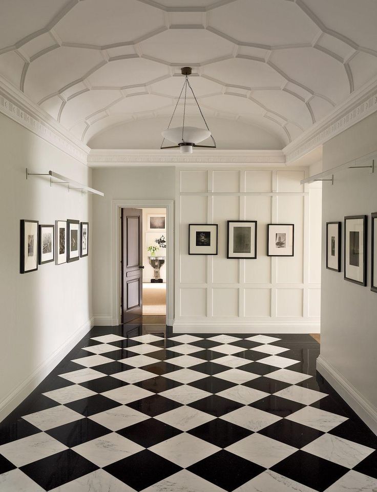 a black and white checkered floor with two chairs next to a table in the middle