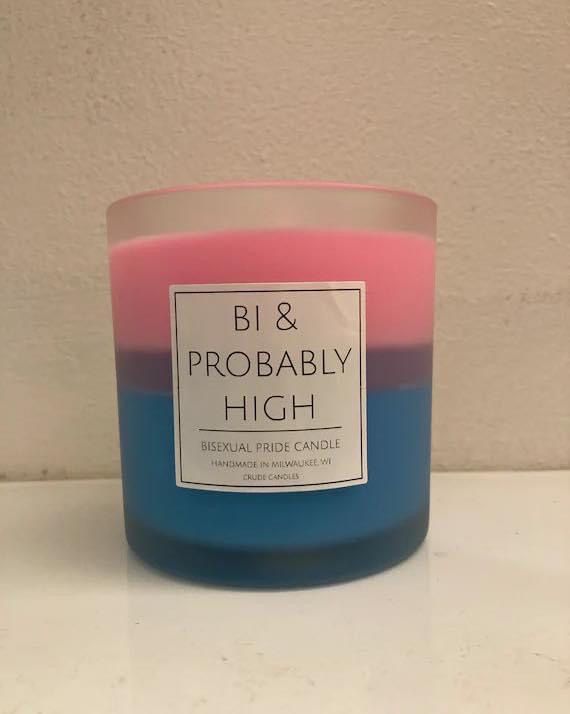 a pink and blue candle sitting on top of a counter