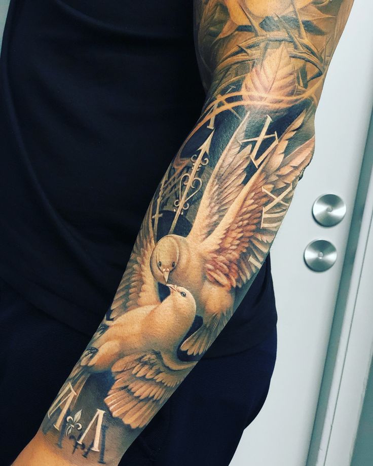 a person with a tattoo on their arm and an owl in the middle of it