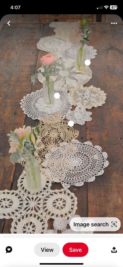 the table is covered with doily and flowers