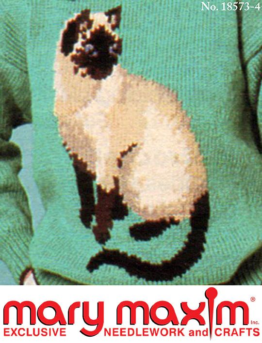 a woman wearing a green sweater with a cat on it