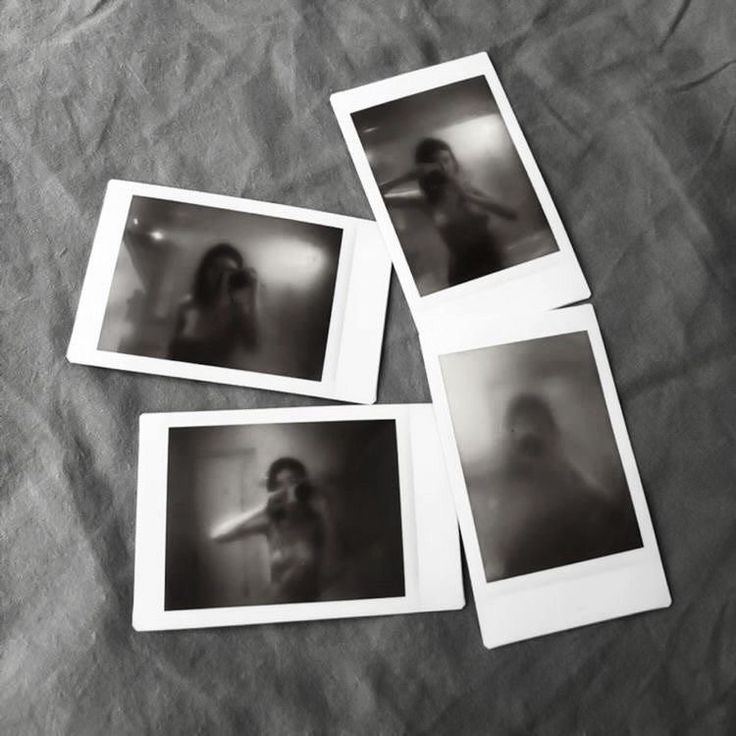 four polaroid photos are laying on a bed with the sheets pulled back to reveal an image