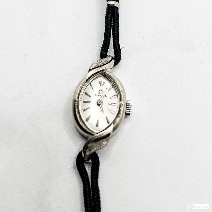 Vintage Ladies Omega Watch 14k White Gold Manual Wind Swiss Made Original Cloth Canvas Strap Antique White Gold Watch With Polished Finish, Antique White Gold Watches With Polished Finish, Evening White Gold Watch With Chronometer, Evening White Gold Chronometer Watch, Elegant Silver Oval Diamond Watch, Timeless White Gold Watch For Evening, Timeless Formal Jewelry And Watches With Clasp, Elegant Formal Jewelry And Watches With Clasp, Classic Hallmarked White Gold Diamond Watch