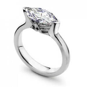 a white gold ring with a pear shaped diamond