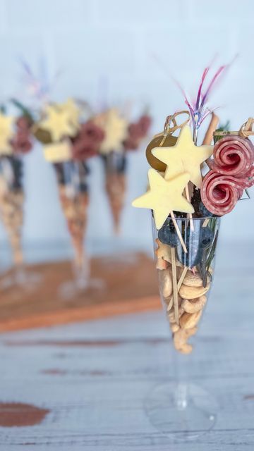 there are flowers in the vases with sticks sticking out of them on the table