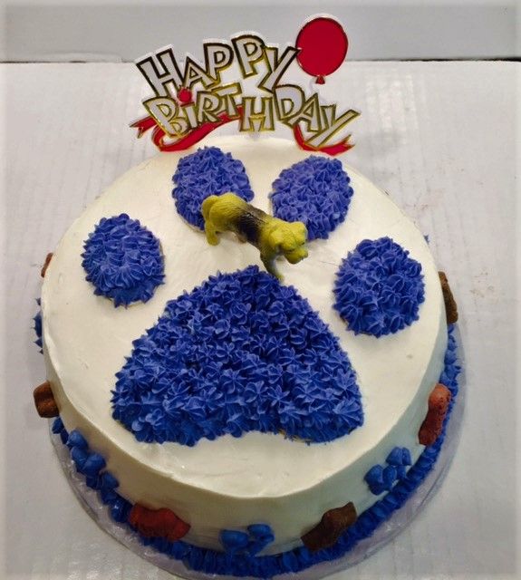 a birthday cake decorated with blue frosting and an image of a dog's head