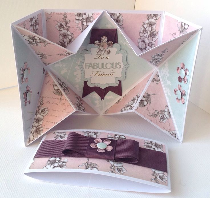 an origami box with ribbon and bow on it