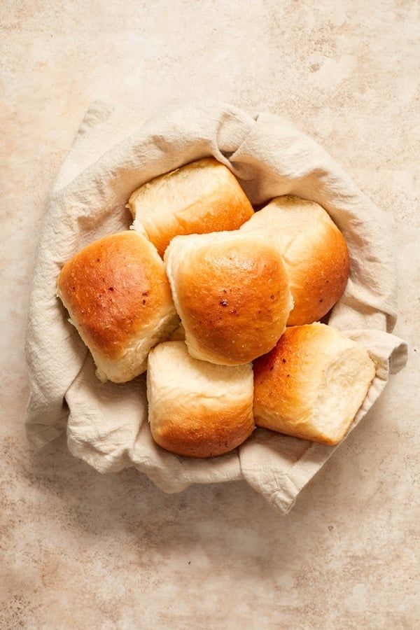 small rolls in a paper bag on a counter top, ready to be baked or eaten