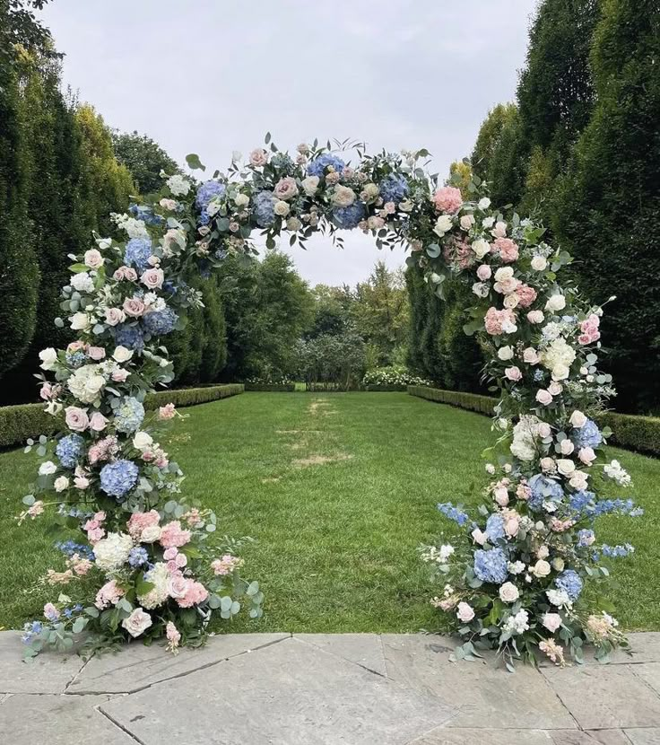 two floral archways with blue and pink flowers