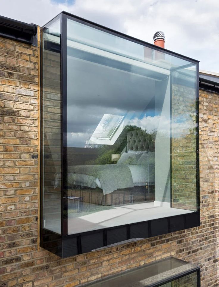 a large glass window on the side of a brick building