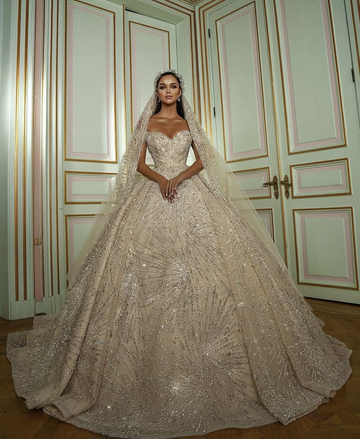 a woman in a wedding dress standing next to a closet with gold trimmings