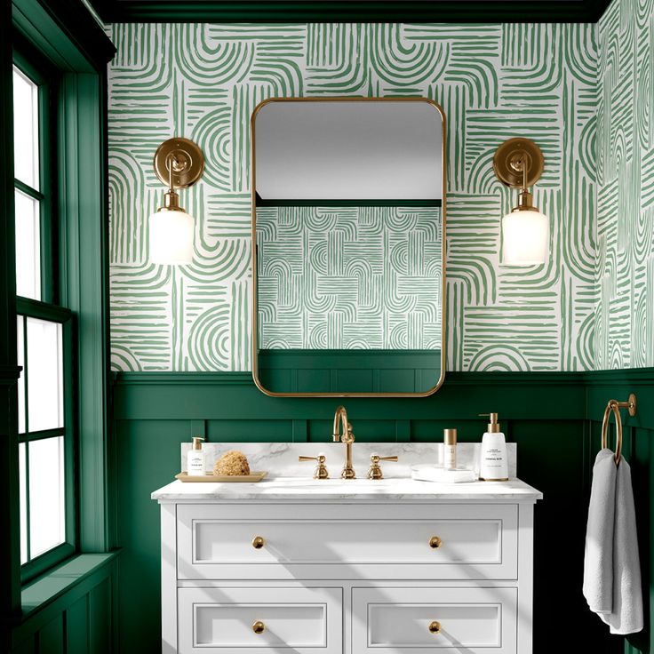 a bathroom with green wallpaper and gold fixtures