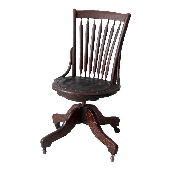 an old wooden desk chair with wheels on the back and footrests, sitting against a white background