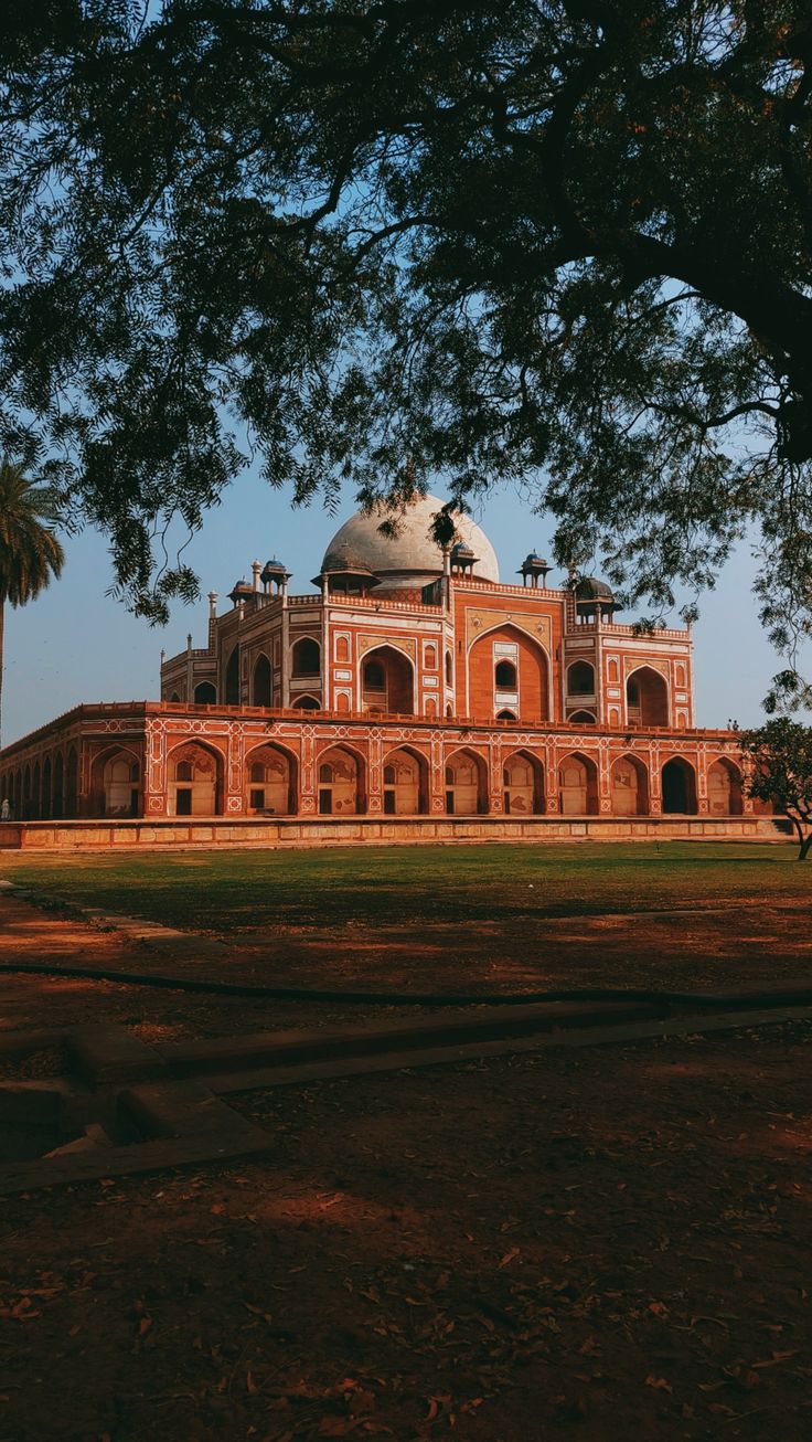 an old building is surrounded by trees and grass