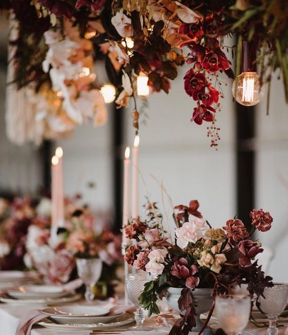 the table is set with candles, flowers and plates for an elegant dinner party or wedding reception