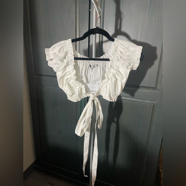 Nwt. White Cropped Blouse. Long String So You Can Either Tie It In The Front Or Around You. Super Cute!!! Size Xs/S White Ruffled Crop Top Blouse, White Cropped Blouse For Vacation, White Crop Top Blouse For Beach, White Crop Top Blouse For The Beach, White Cropped Feminine Blouse, White Feminine Cropped Blouse, Feminine White Cropped Blouse, White Fitted Crop Top For Daywear, White Crop Top Blouse For Daywear