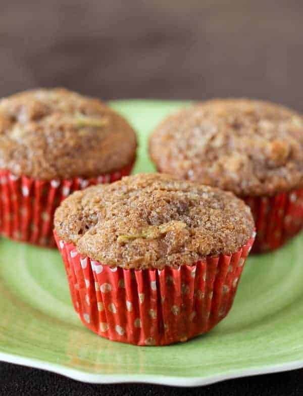 three muffins are sitting on a green plate