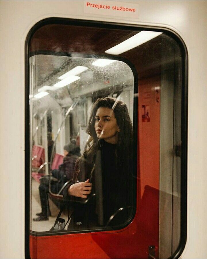 a woman looking out the window of a train