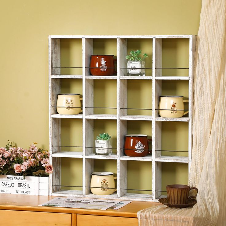 a wooden shelf filled with lots of cups