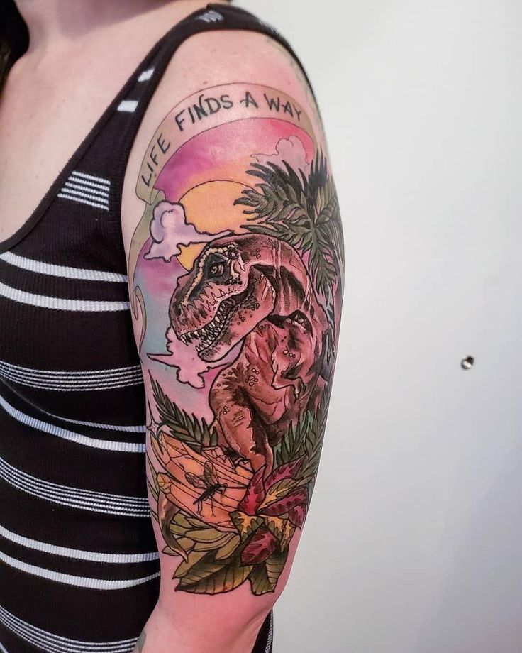 a woman with a dinosaur tattoo on her arm