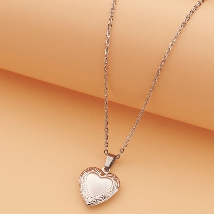 Adorn your neckline with a heart locket pendant necklace, elegantly crafted in gold-plated stainless steel for a timeless and sentimental accessory. Material: Stainless Steel 18k Gold plated Chain length: 40cm+ 5cm/ 16"+2" Pendant: 22mm / 0.9" Weight: 7g Timeframes may be extended during the lead up to the peak holiday season, so please get your orders in early. All individual items will be shipped separately within each order.We will contact you if we require any clarification or further details for your order. Order a Love Locket Necklac today and surprise your loved ones with a secret message they can cherish forever ❤ Rose Gold Pendant Locket Necklace With Adjustable Chain, Dainty Rose Gold Heart Locket Necklace, Elegant Heart Pendant Locket Necklace In Metal, Elegant Metal Heart Pendant Locket Necklace, Elegant Heart Pendant Locket Necklace, Rose Gold Heart Pendant Locket Necklaces, Elegant Metal Locket Necklace For Valentine's Day, Rose Gold Charm Necklaces With Locket For Mother's Day, Rose Gold Locket Charm Necklaces For Mother's Day