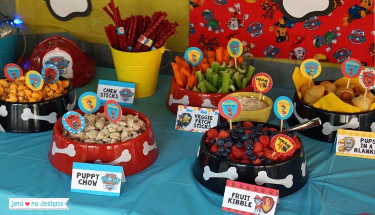 a table topped with lots of different types of food and snacks on top of it