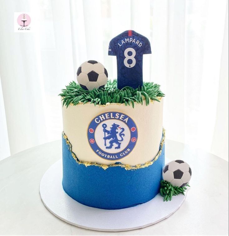 there is a cake with soccer balls on the top and number 8 in the middle