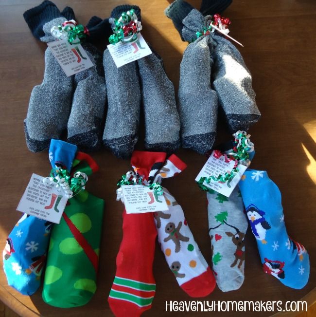 several pairs of socks are sitting on a table with tags attached to the sock holders