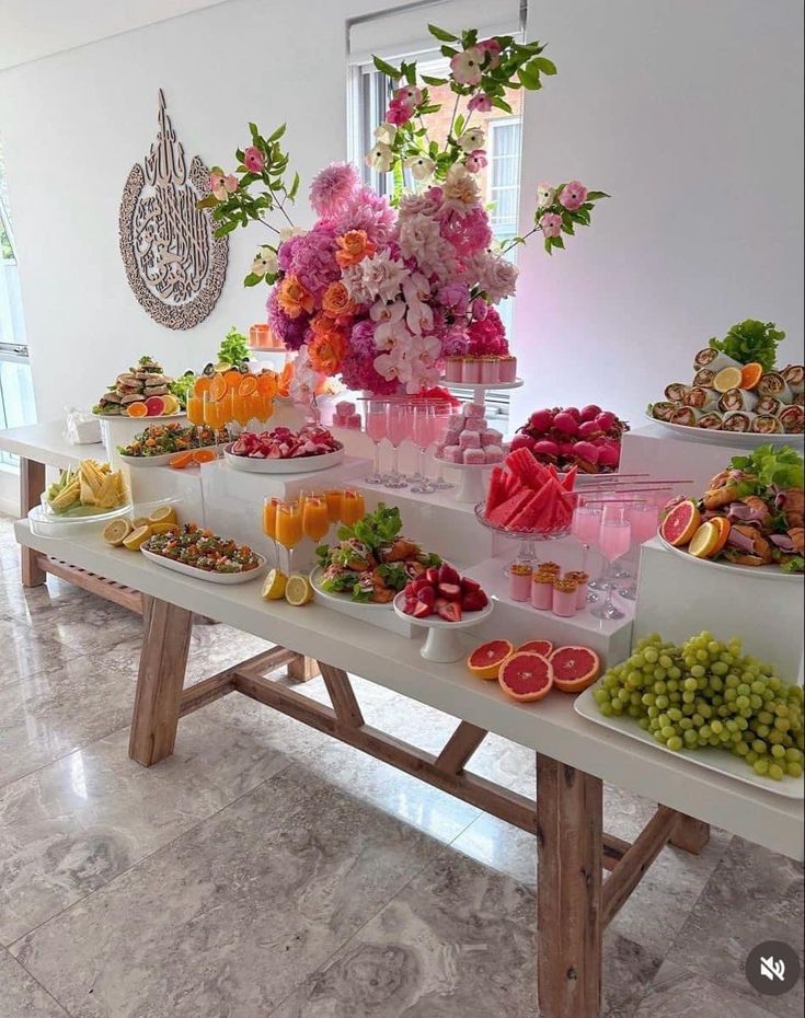 a table filled with lots of different types of fruits and flowers on top of it