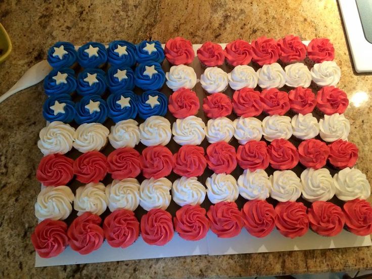 cupcakes with red, white and blue frosting are arranged in the shape of an american flag