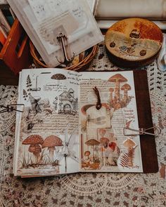 an open book sitting on top of a table next to a basket filled with items