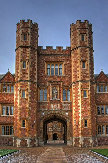 an old brick building with a stone walkway leading to it