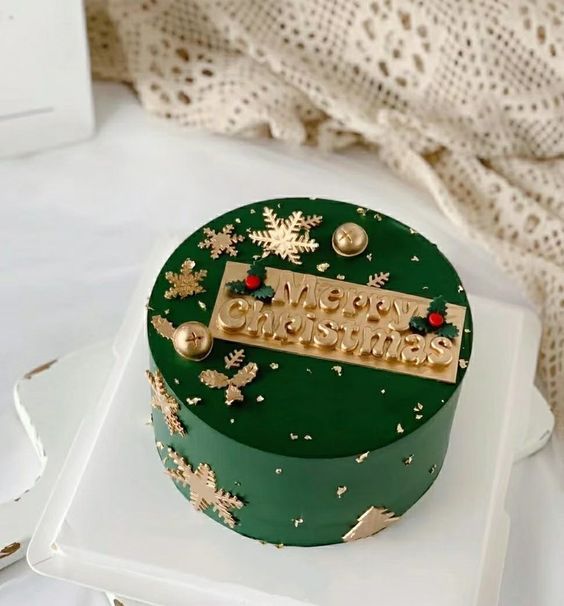 a green and gold christmas cake on a white plate