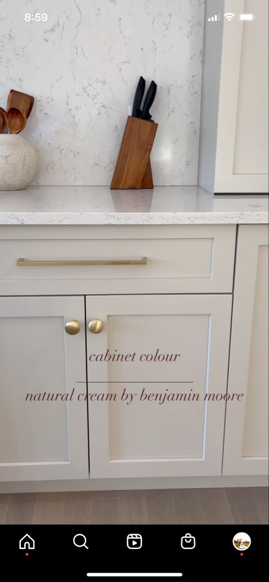 a kitchen with white cabinets and marble counter tops in the center is an inscription on the cabinet door