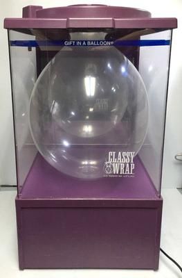 a glass ball in a purple display case