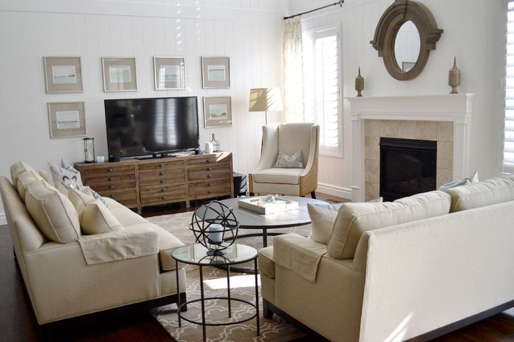 a living room filled with furniture and a flat screen tv on top of a fireplace