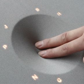 a person's hand is touching the surface of a computer keyboard with letters on it