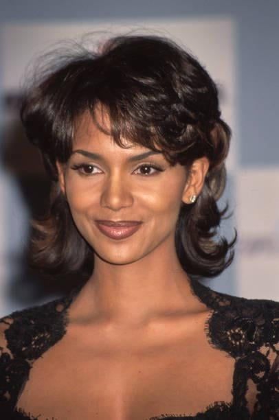 a close up of a person wearing a dress and smiling at the camera with a smile on her face