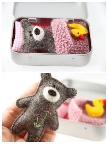 there are two pictures of stuffed animals in a tin with pink and gray material, one is holding a yellow rubber duck