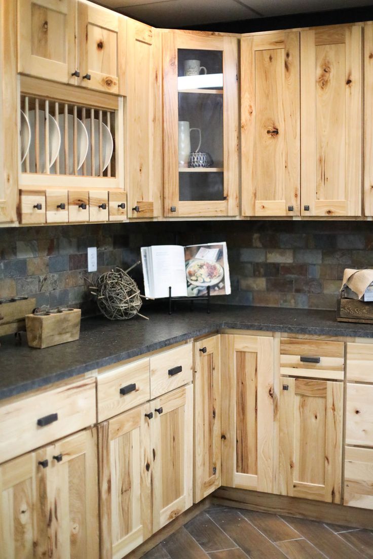 a kitchen with wooden cabinets and granite counter tops