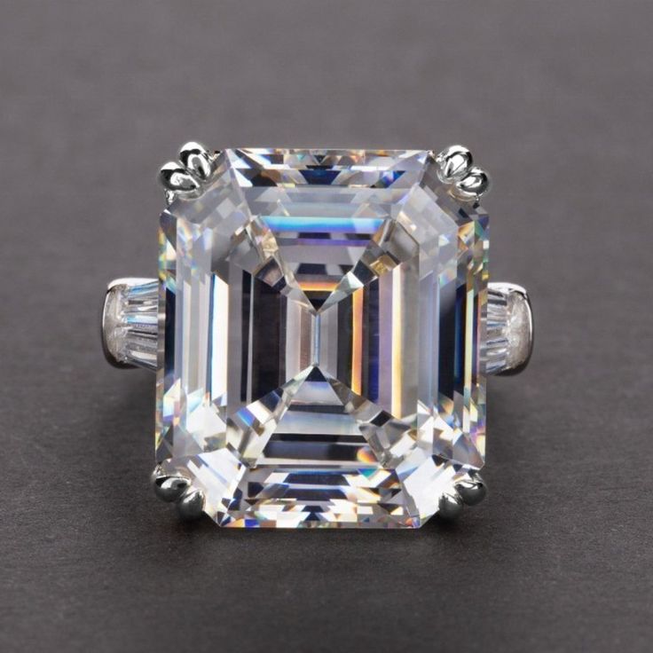 an emerald cut diamond ring with three baguets