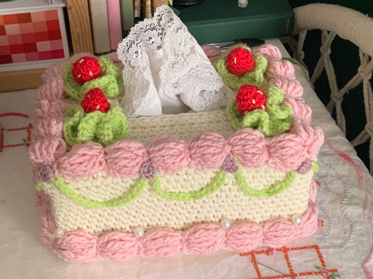 a crocheted cake sitting on top of a table