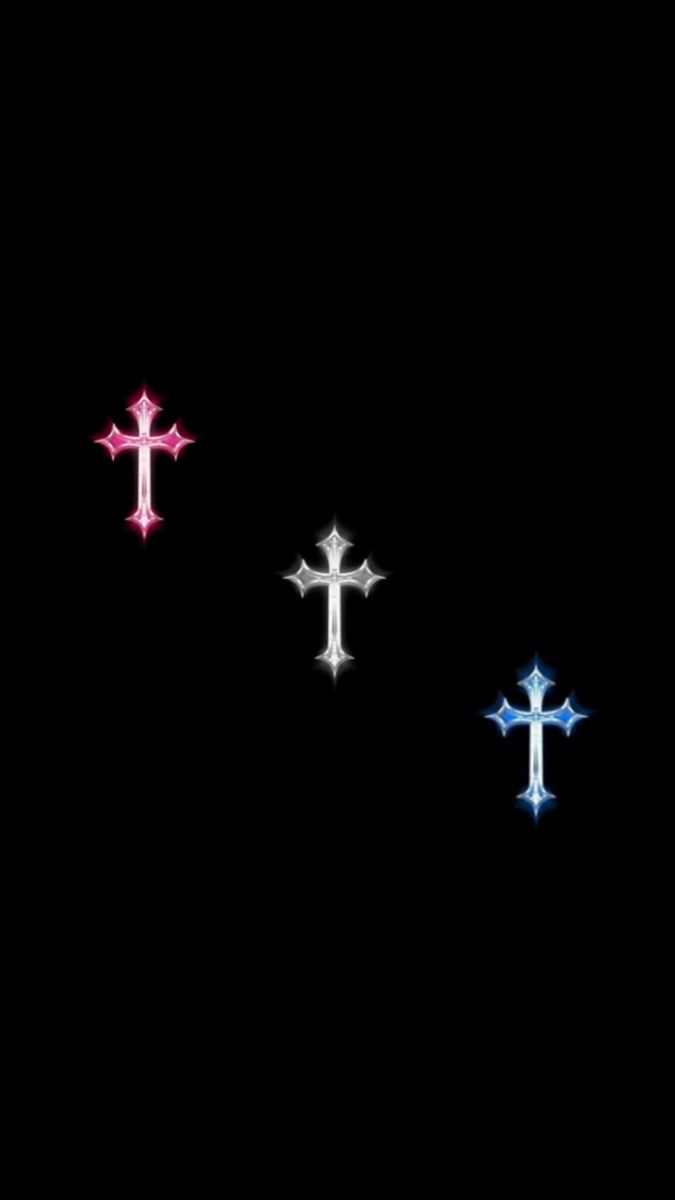 three crosses are lit up in the dark with colored lights on them and one is red, white, and blue