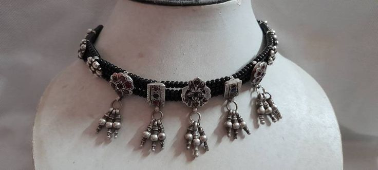 Vintage 1980s Handmade Rare Real Old High Grade Old Silver Rajasthan Tribal Banjara Jewelery Kanthi 24 inches Black New cotton Threaded Black glass beads adjustable Necklace made By someone else Discovered and collect by me primary Color of Necklace Silver is vintage / Pre owned Old Looks Weight of Necklace is 42.7 gms Length of Pendants is 4.2 cm.with Dangles Width of center Pendants is 1.5 cm Used color Tiny glass beads for decoration in Necklace It's a totally Handmade tribal banjara antique Traditional Oxidized Finish Necklace For Party, Traditional Beaded Chain Choker, Traditional Adjustable Metal Beaded Necklaces, Vintage Silver Beads Necklace For Festivals, Vintage Adjustable Beaded Necklaces For Festivals, Traditional Beaded Chain Jewelry For Party, Traditional Party Jewelry With Beaded Chain, Traditional Metal Necklace With Round Beads, Traditional Beaded Chain Necklaces For Festival