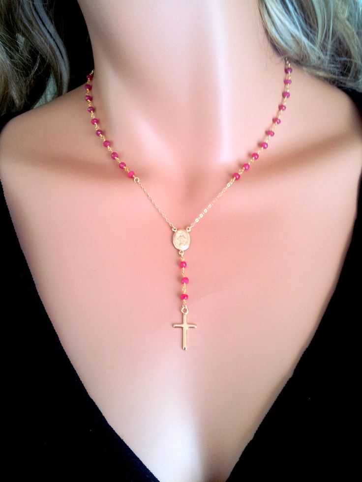 "This is a gorgeous rosary necklace with genuine 4mm faceted Ruby gemstones on 14kt gold filled chain. The beautiful goldfilled oval Miraculous Mary medallion hangs at center with 3\" drop that has a 1/2\" gold filled cross pendant. Necklace may be ordered in a 16\", 18\", 20\", 22\", or 24\" length around the neck. (Priced accordingly, you choose size). Has spring closer clasp in back. Comes beautifully boxed, the perfect gift! *Model is wearing a 16\" length. This style necklace also comes in Ruby Cross Necklace, Gold Crucifix Necklace With Miraculous Medal, Spiritual Crucifix Necklace With 8mm Beads, Red Rosary Necklace, Ruby Cross Pendant, Gold Rosary Necklace, 14kt Gold Jewelry, Catholic Cross, Necklace Ruby