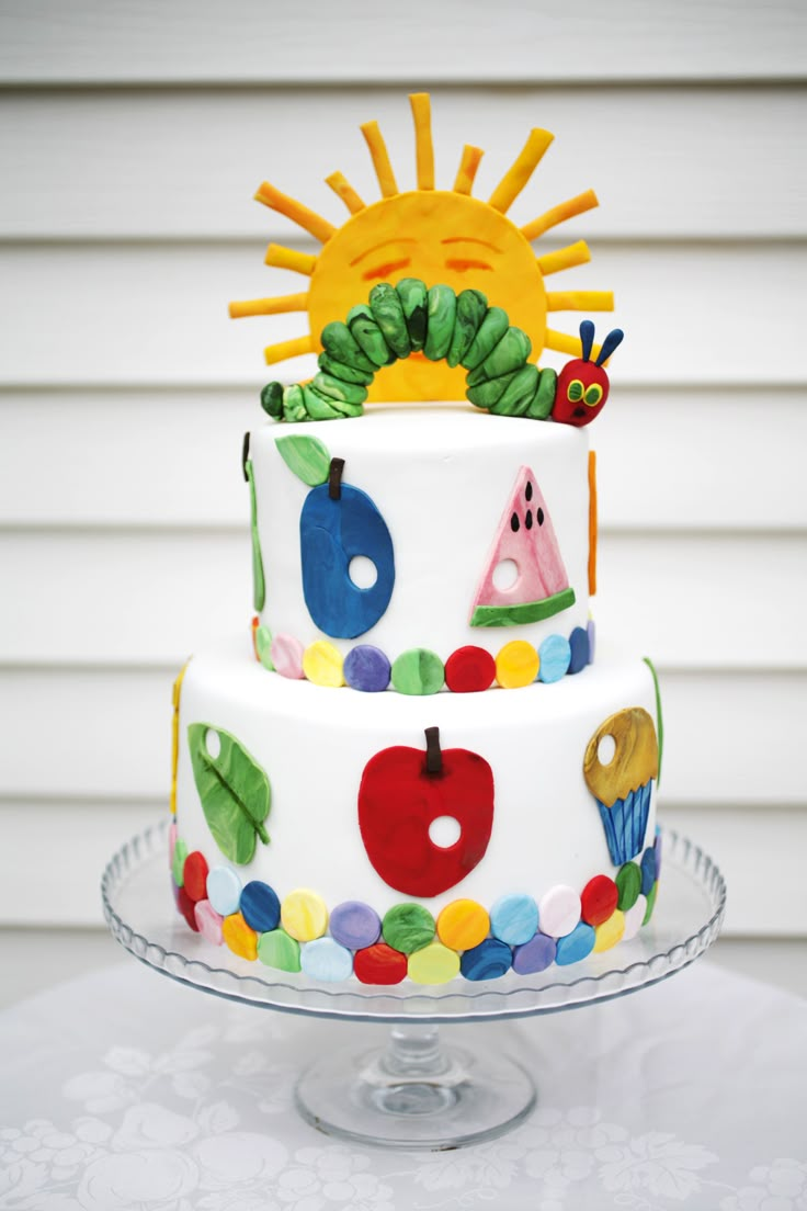 the very colorful cake is decorated with an image of the very hungry caterpillar