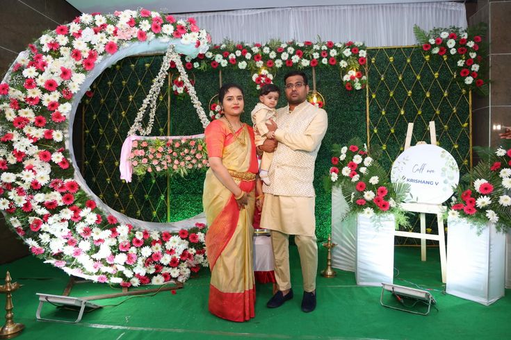 a man and woman standing in front of a floral display