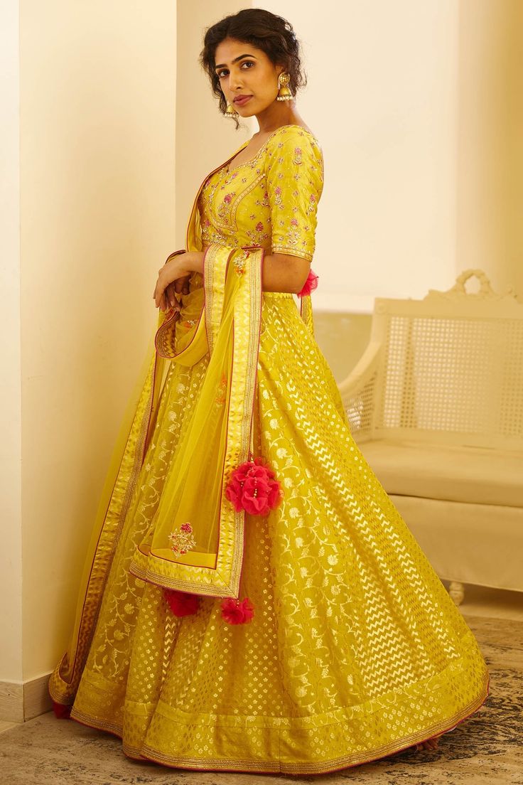 Yellow blouse with zardozi embroidered floral motifs. Paired with foil print lehenga and embroidered dupatta.
Components: 3
Fabric: Silk jaquard, Chanderi, jaquard
Neckline: Sweetheart
Sleeve Length: Half
Color: Yellow
Embroidery
Low back with tie up and tassels
Dupatta with embroidered border and tassels
Closure: 
Blouse: Hook back - Aza Fashions Semi-stitched Anarkali Lehenga With Meenakari, Traditional Drape Dola Silk Choli With Meenakari, Brocade Embroidered Dupatta Fabric For Reception, Reception Brocade Salwar Kameez With Zari Work, Gold Embroidered Fabric For Designer Wear Navratri, Gold Floor-length Embroidered Fabric For Festivals, Navratri Gota Work Embroidered Fabric For Reception, Festive Brocade Embroidered Fabric For Reception, Transitional Anarkali Gold Lehenga