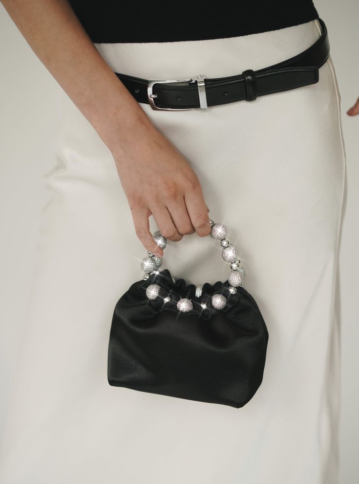 Details Featuring crystal wraparound handle, this satin handbag from the SS 2022 collection offers a timelessly chic look. It is your next NIGHT OUT BAG! Satin lining Crystal wraparound handle Size Length: 16 cm Height: 20.5 cm (With the handle) Width: 11.5 cm 6.30"L x 8.07"H x 4.53"W 0.65 lbs weight Shipping & Return Free US shipping on orders over $100.Free International shipping on orders over $300. For more details click HERE. Chic Top Handle Evening Bag For Events, Luxury Pouch Evening Bag With Pearl Handle, Luxury Evening Bag With Pearl Handle, Elegant Clutch With Round Handle For Formal Occasions, Elegant Evening Bag With Round Handle, Elegant Formal Clutch With Round Handle, Chic Evening Bag With Detachable Handle For Events, Luxury Evening Bag With Handle Drop, Elegant Clutch With Pearl Top Handle